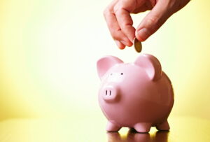 coins-being-put-into-a-piggy-bank