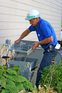 technician-opening-an-outdoor-AC-unit-to-access-the-compressor